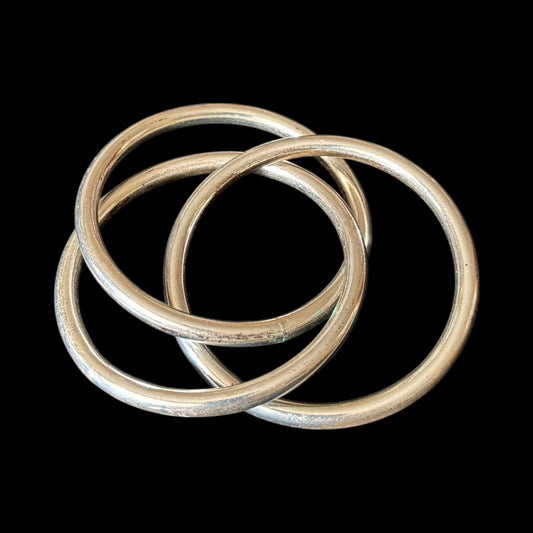 Three intertwined silver bangles