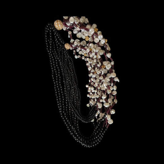 Beautiful and elegant necklace with strings of black beads and fresh water pearls