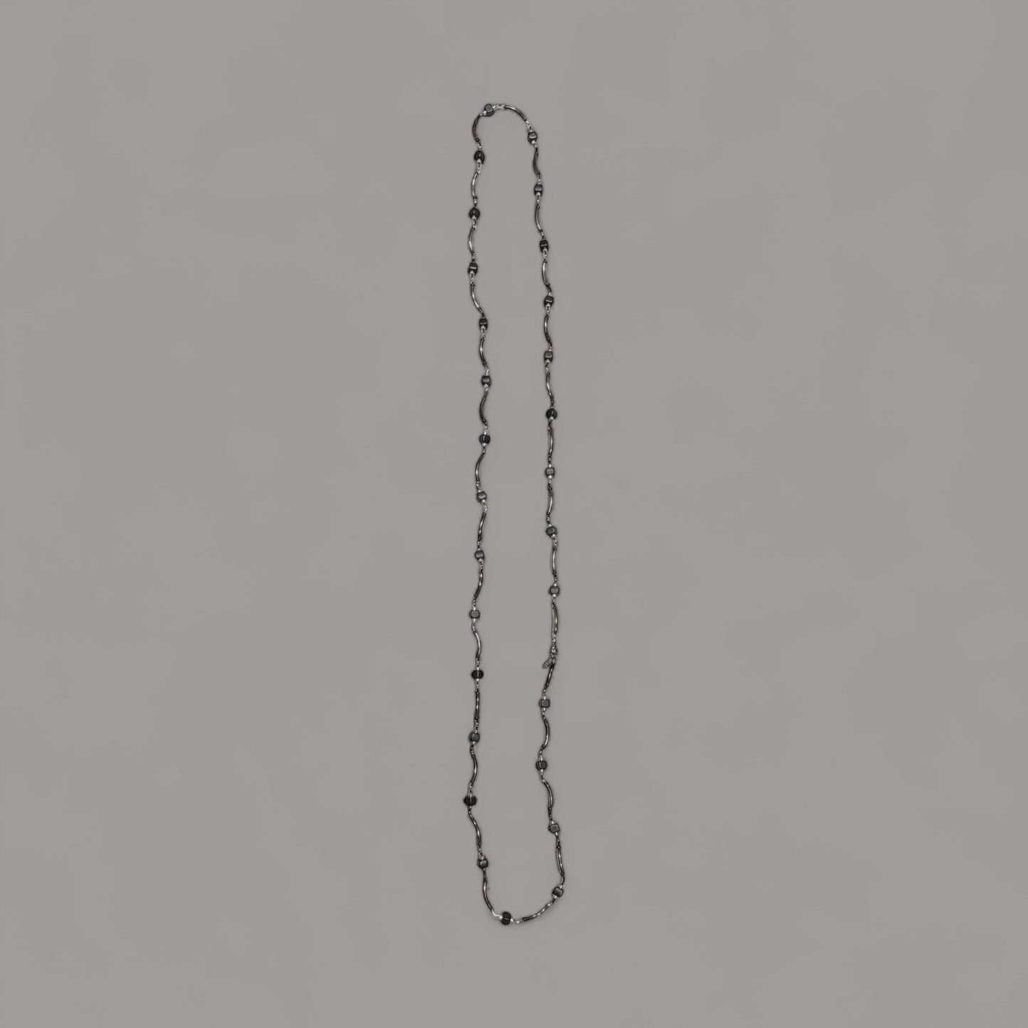 Long twisted metal chain with black beads to enhance the look