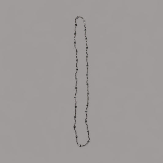 Long twisted metal chain with black beads to enhance the look