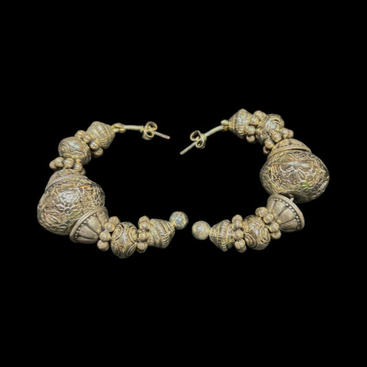 Half hoop silver  piearced earring featuring intricatley degined spherical forms
