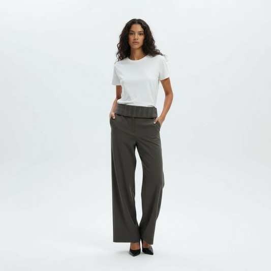 Woman wearing a white t-shirt and gray high-waisted pants on a white background