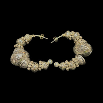 Half hoop silver  piearced earring featuring intricatley degined spherical forms